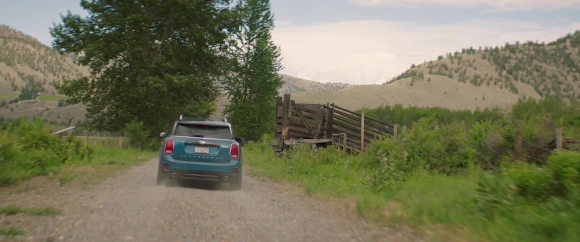 Blue travels on dirt road in mountain canyon