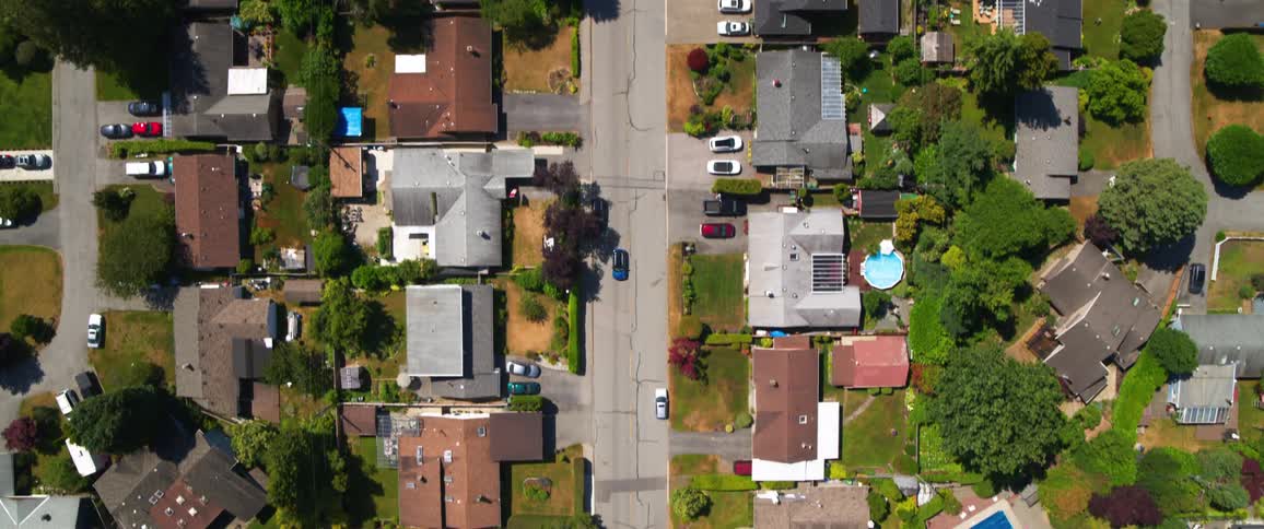 Aerial view of vehicle driving on suburban street