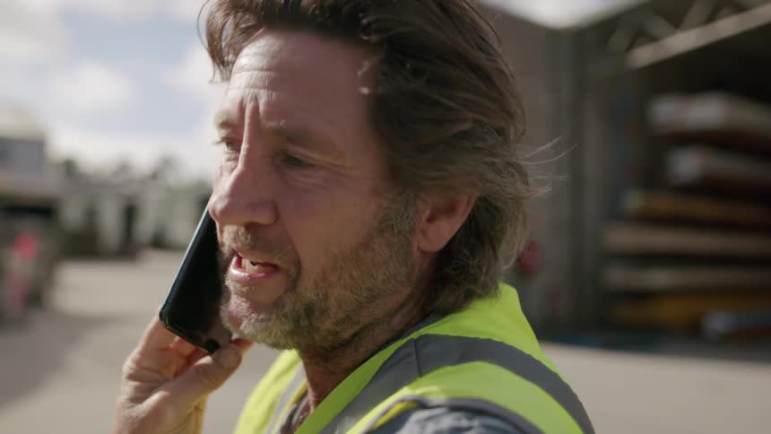 A man is talking on his phone outside