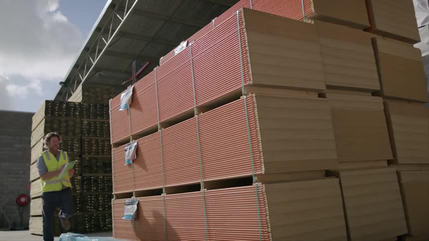 Man with a clipboard inspecting a warehouse