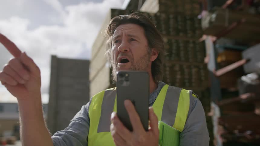 A worker having a video call with his cellphone