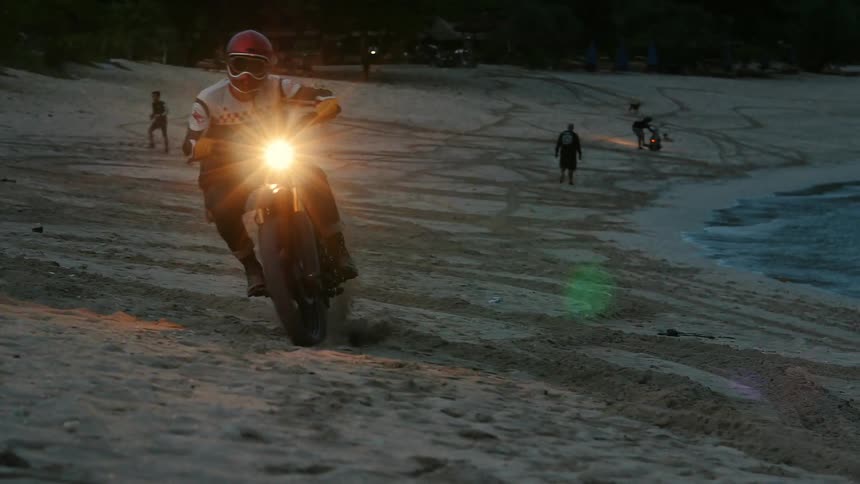 Person riding a dirt bike at night
