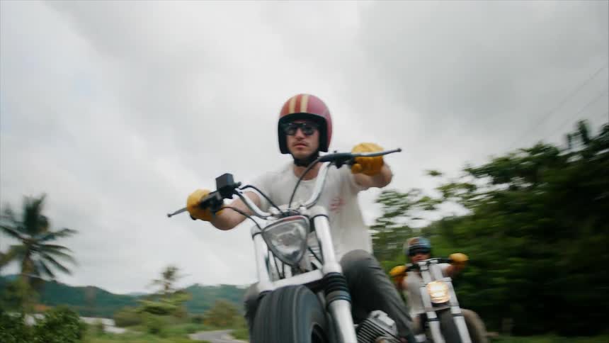 Group of motorcyclists riding on a cloudy day