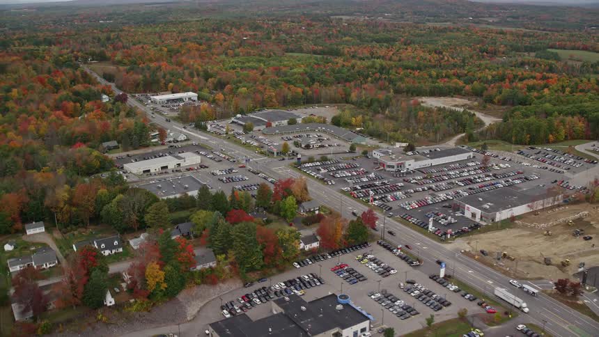 Vehicles travel down the road past the warehouses