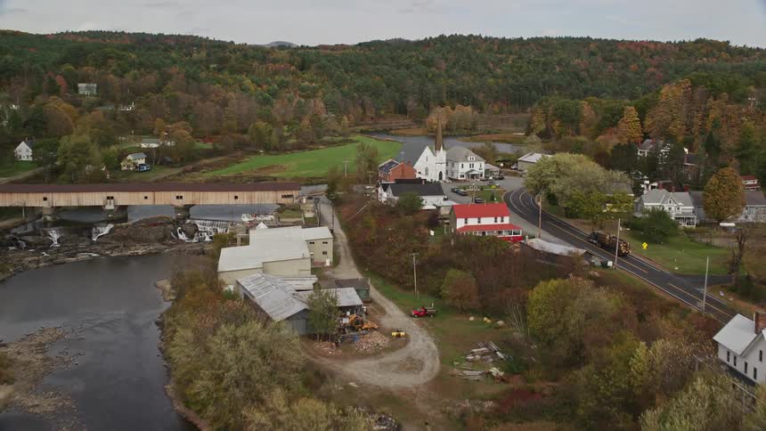 Aerial of a small rural town with river and forest