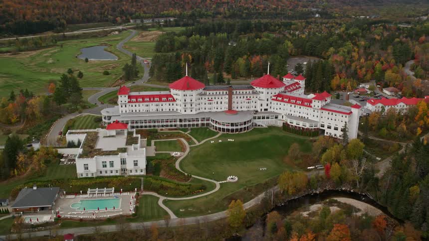 Aerial of isolated building with many rooms and an outside swimming pool