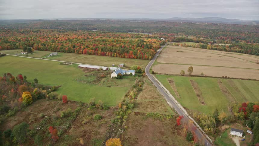 Farm houses in the rural area with trees surrounding the area