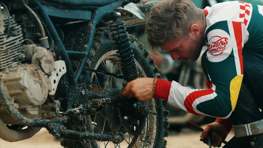 A mechanic working on a motorbike