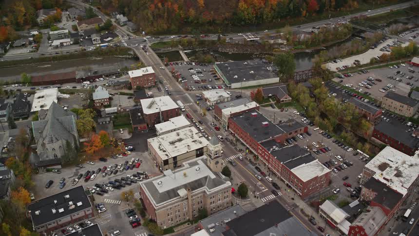 A suburban region of a city with several cars passing through the streets
