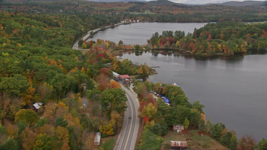 Cars drive past the river