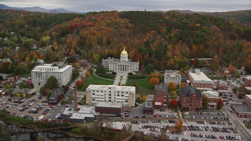 A city hall building of a small town in the middle of forests that are on hills