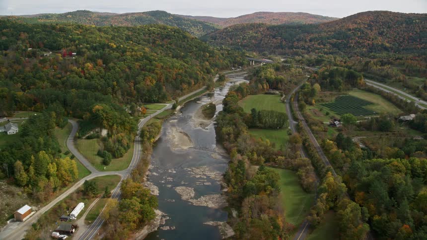 A river in a small rural town surrounded by forest