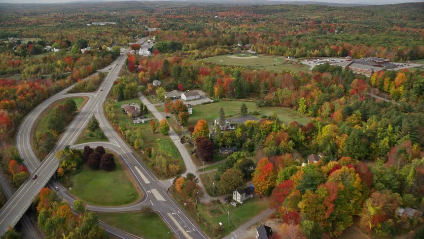 Aerial of multilane road with moving cars at city outskirt