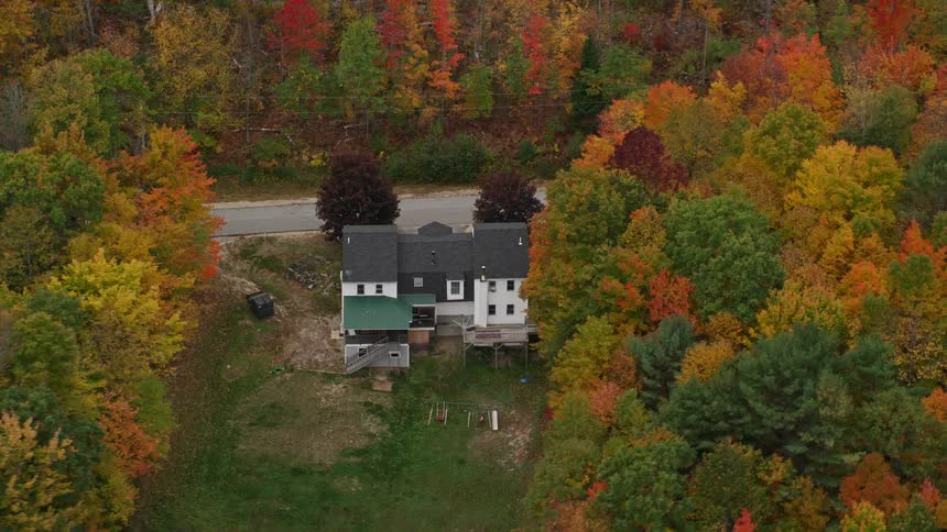 Aerial view of a house surrounded by forests in the countryside