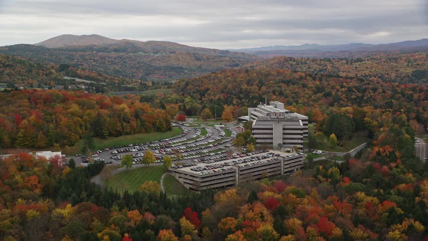 Aerial of a large office building in a rural area on a cloudy autumn day