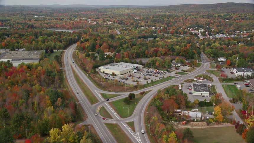 Vehicles travel on the highway past the town