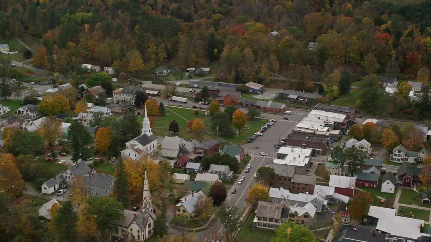 Cars drive through the small town