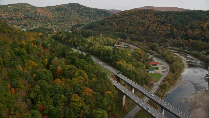 Traffic runs over the highway past the river