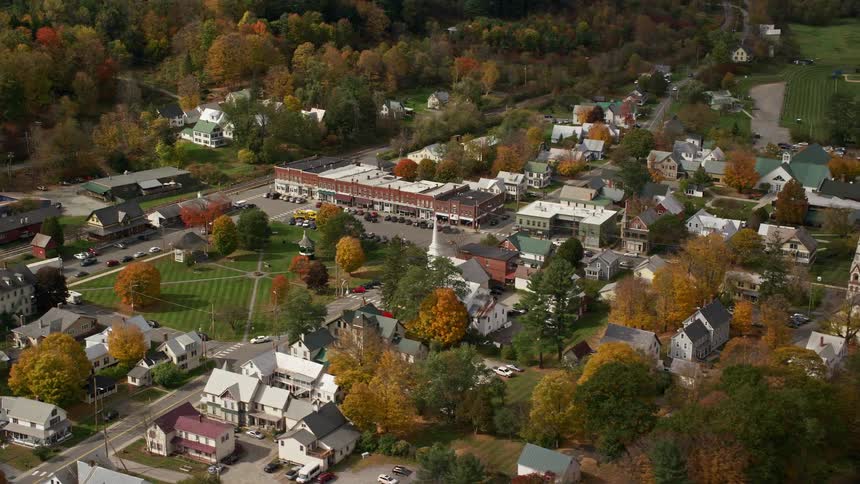 A small rural town with lots of trees inside and outside the city