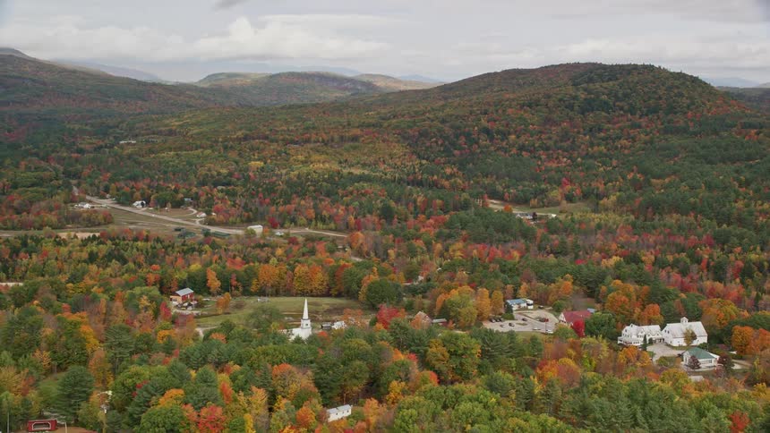 Aerial view of a town in a forested area during autumn