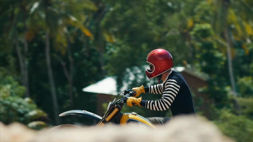 Motorcyclist climbing a dirt hill