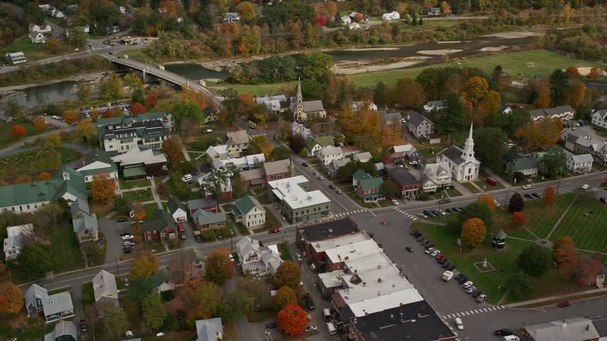 A small town with lots of trees and a small river nearby