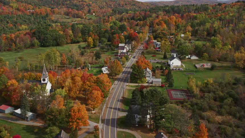 A rural region with some houses facing a single street that passes by