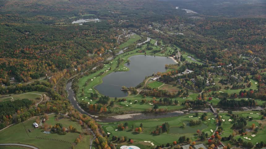 Aerial view of golf course and trees in autumn