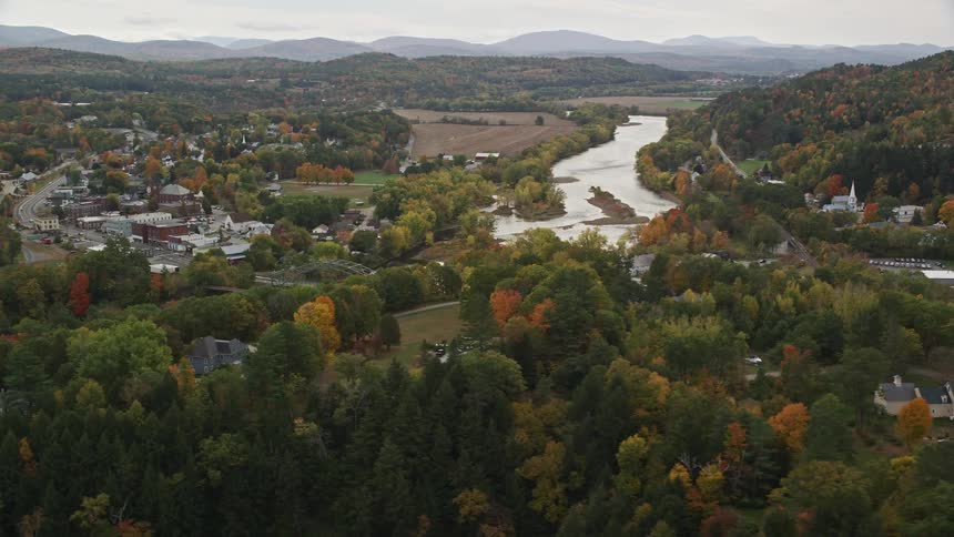 Aerial view of a river through next to a small town in the countryside