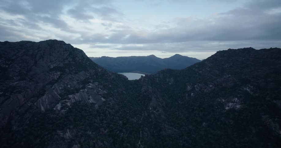 Landscape of a mountain range with peaks and a central lake