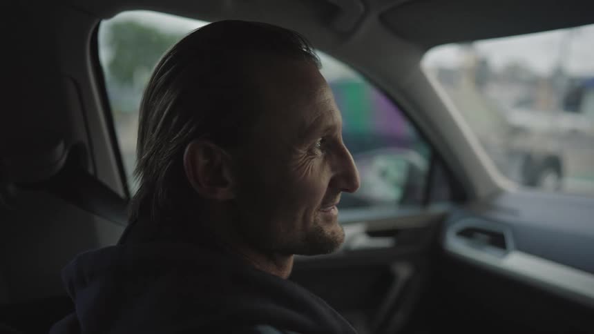 A man is talking in the car