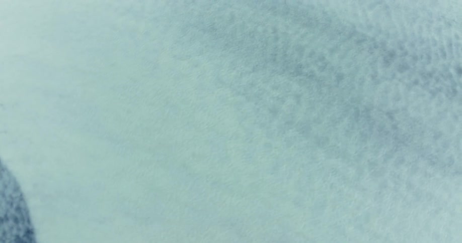 A blue and white surface with a sandy texture