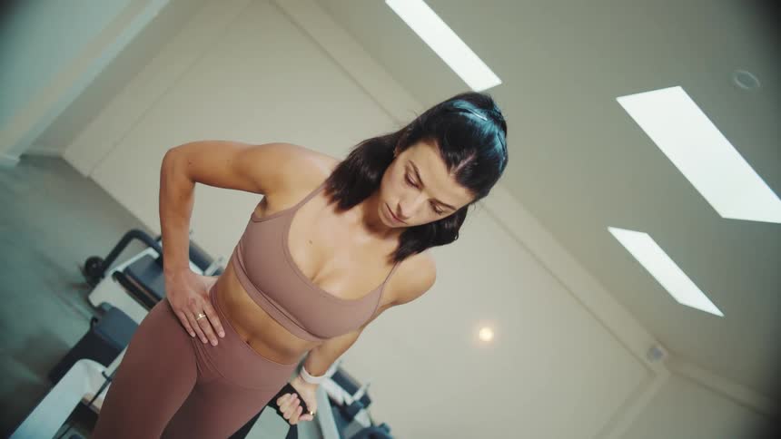 Woman exercises on exercise machine indoors
