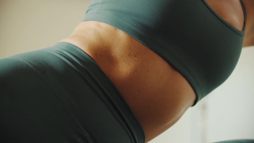 Close up of the torso of a woman stretching