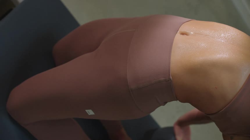 Woman sweats while maintaining yoga pose