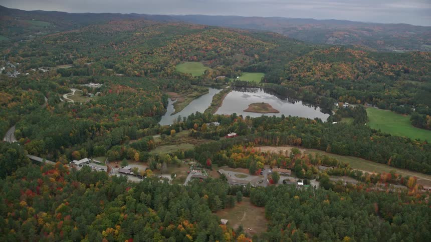 The homes are surrounded by hills and trees