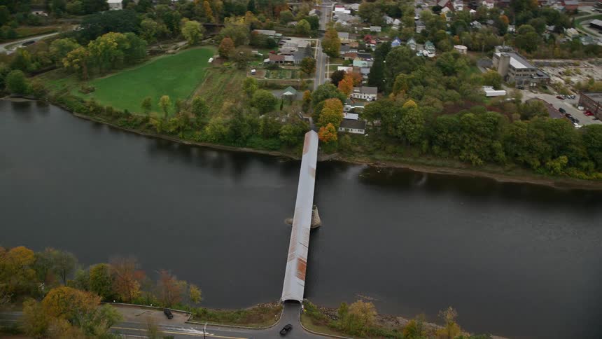 Skyline of a river in a residential neighborhood with a bridge over the river