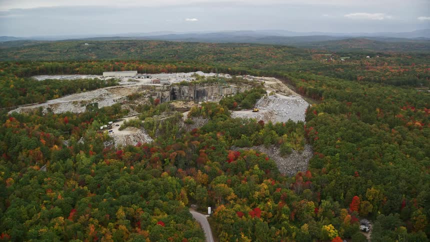 An aerial panorama of a stone quarry in the middle of a forest
