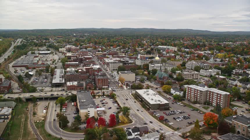 Aerial of traffic flowing through town during fall