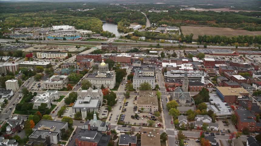 Skyline of an urban residential neighborhood with a river and forest