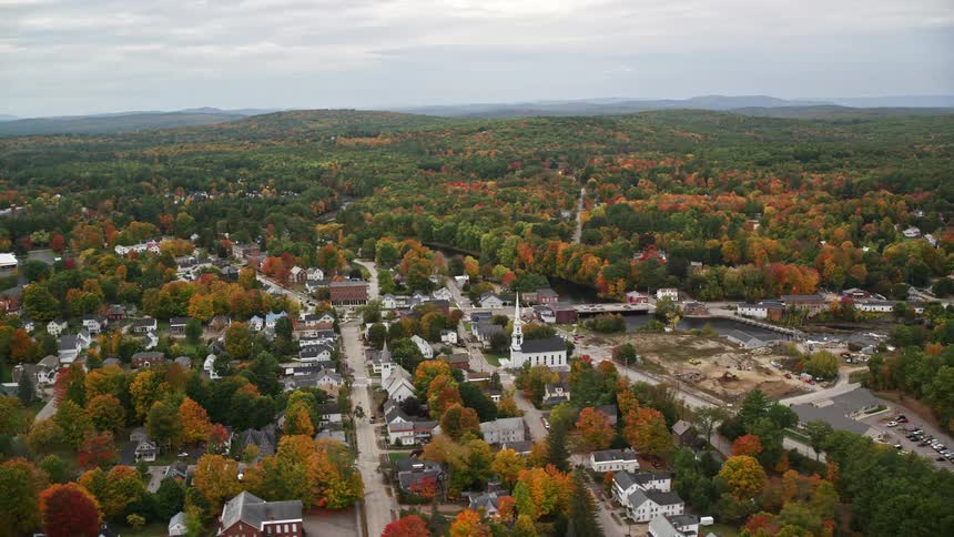 Aerial view of a river and a town and autumn forest