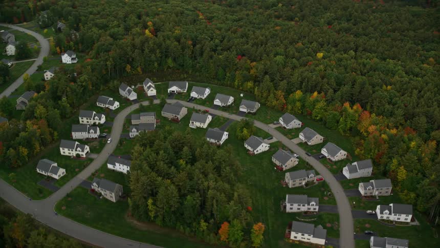 Several identical houses on a circular street in the middle of the forest