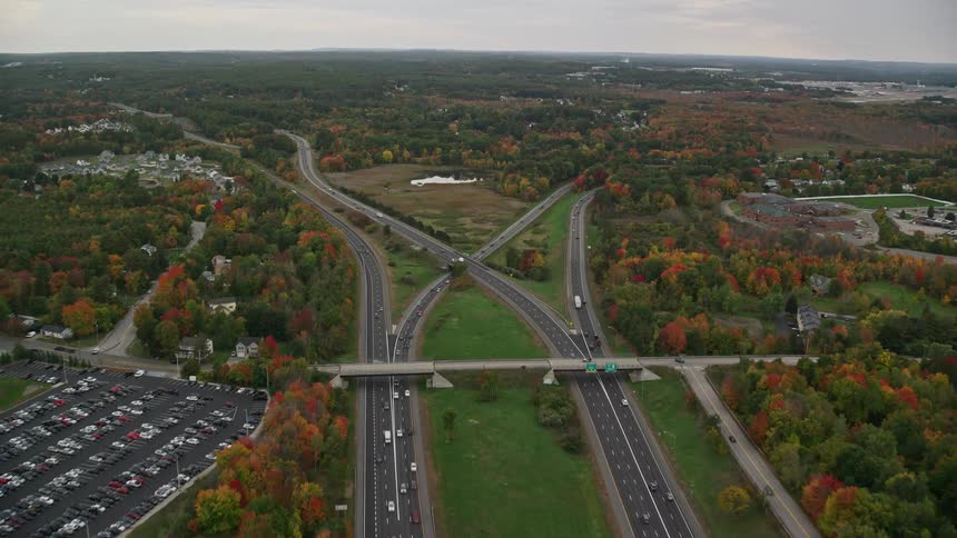 Aerial view of the main highway in a forested urban neighborhood