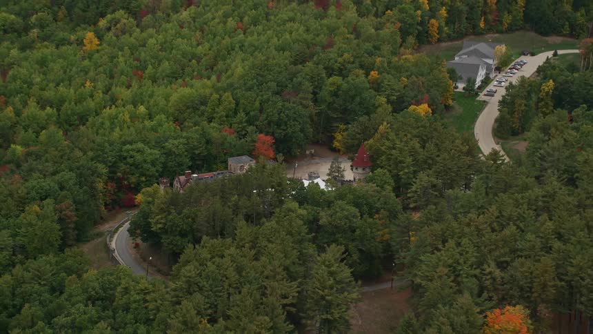 An aerial view of a small castle amidst a forest