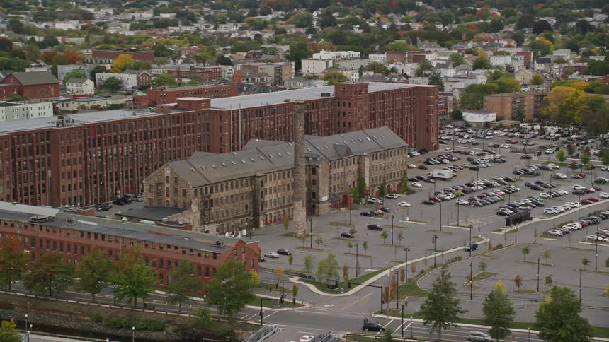 Aerial of an old building with parking during the day