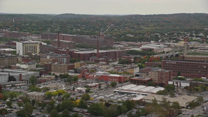 Church and other buildings stand near manufacturing plants in town