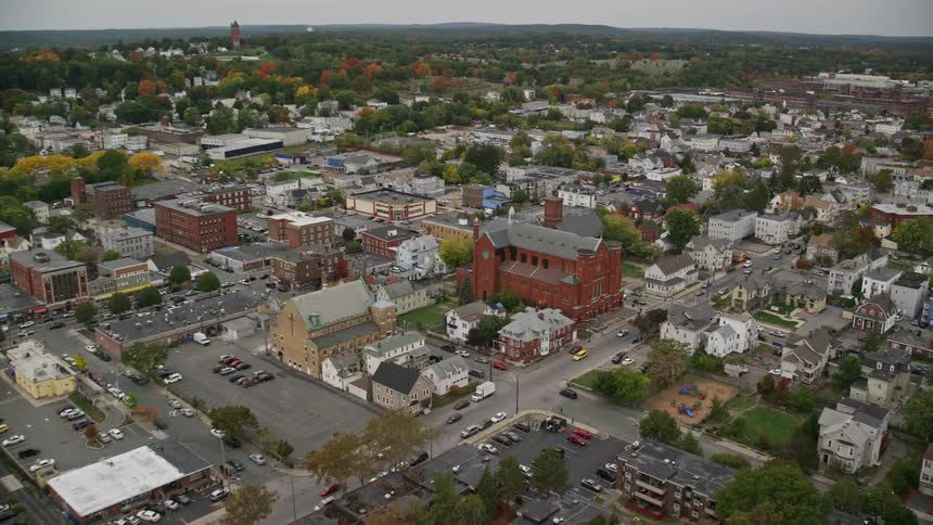 A city with lots of road with intersections as cars drive by