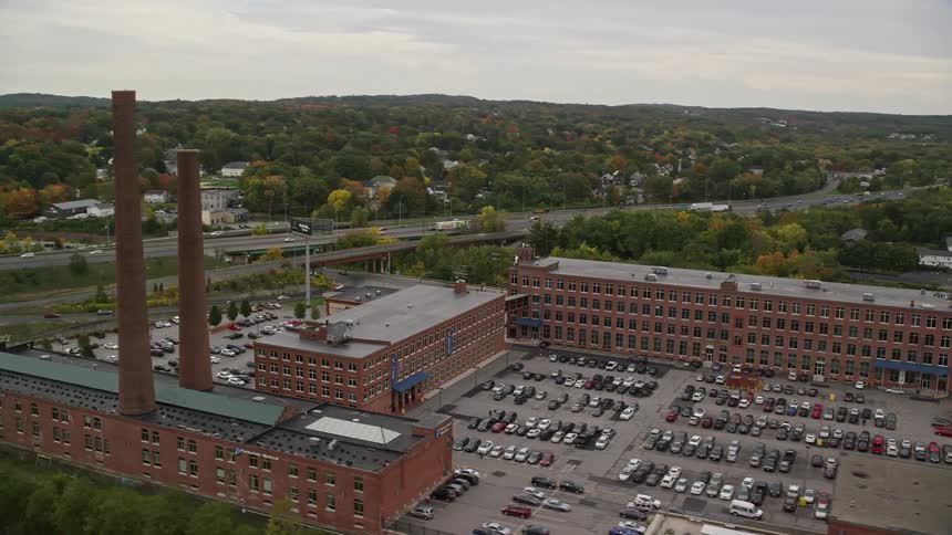 Aerial of a river next to a building with parking