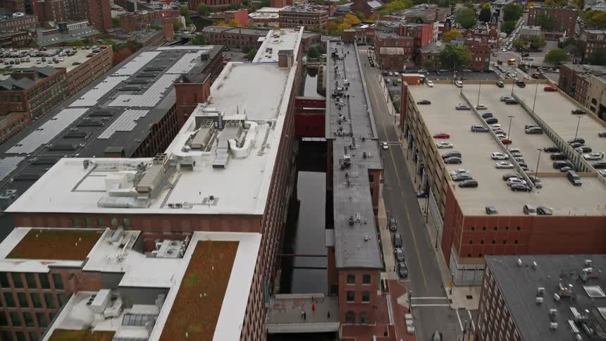 A city view with buildings having parking lots on top of the buildings and beside them