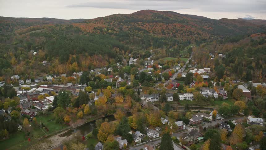 Aerial of a residential neighborhood surrounded by forest and mountains